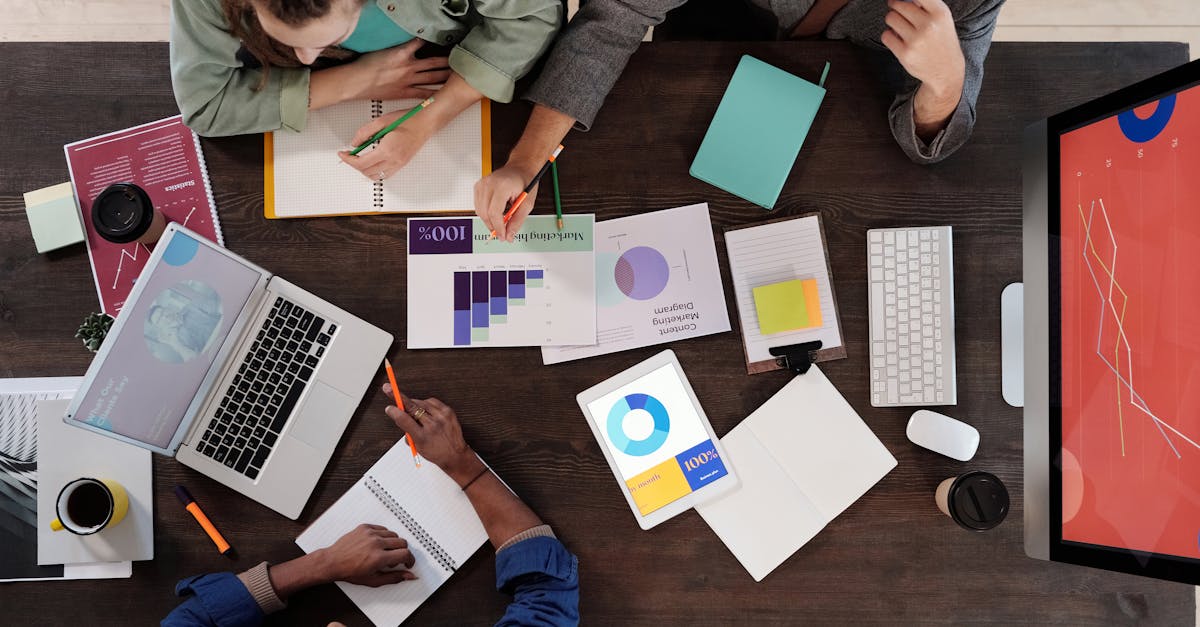 Overhead view of a diverse team collaborating on a project in a modern office setting.